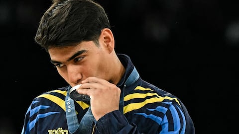 El colombiano Ángel Barajas posa con su medalla de plata durante la ceremonia del podio de la prueba de barra horizontal masculina de gimnasia artística de los Juegos Olímpicos de París 2024 en el Bercy Arena de París, el 5 de agosto de 2024. (Foto de Gabriel BOUYS / AFP)