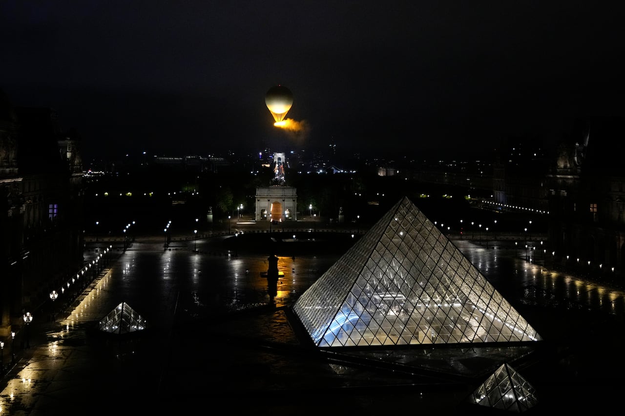 El pebetero, con el fuego olímpico, se eleva al ir colgado con un globo aerostático durante la ceremonia de inauguración de los Juegos Olímpicos de París.